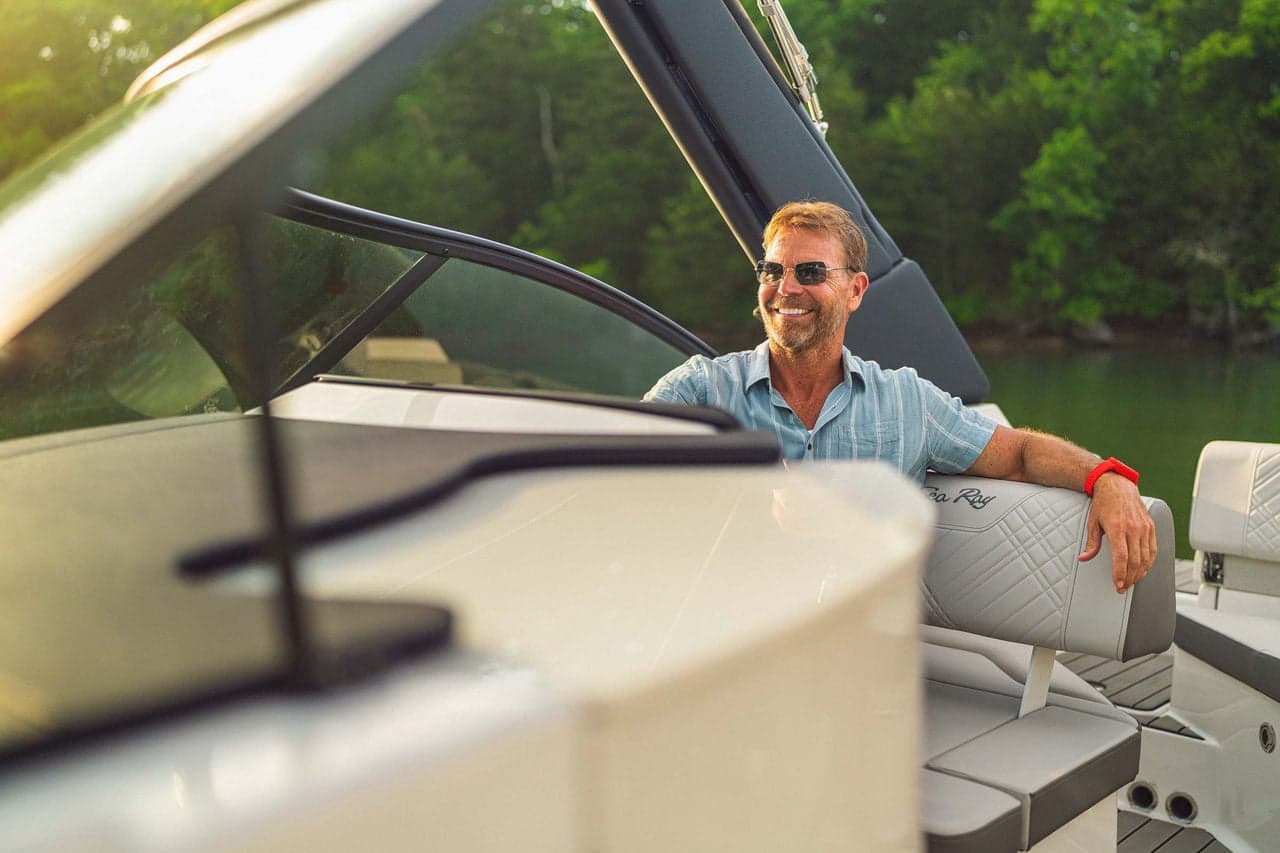 Driver at the SDX 230 helm in clear water