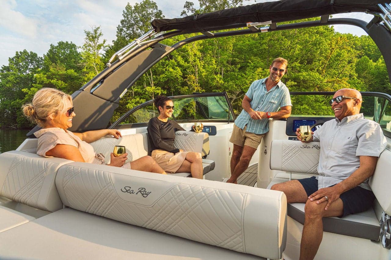 Friends socializing in the cockpit of a Sea Ray SDX 230